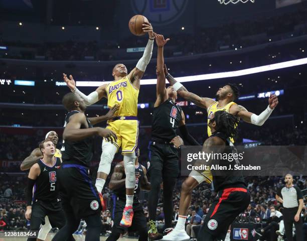 Los Angeles, CA Los Angeles Lakers guard Russell Westbrook, center, drive to the hoop under pressure from Clippers center Serge Ibaka, left, and...
