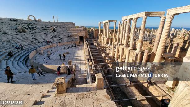 People visit the amphitheatre of the ancient Roman city of Leptis Magna, in the coastal Libyan city of Al-Khums, some 120Km east of the capital...