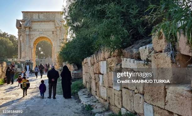 People visit the ancient Roman city of Leptis Magna, in the coastal Libyan city of Al-Khums, some 120Km east of the capital Tripoli, on February 4,...