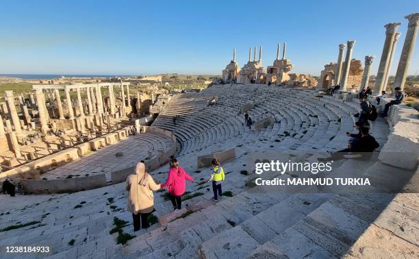 People visit the amphitheatre of the ancient Roman city of Leptis Magna, in the coastal Libyan city of Al-Khums, some 120Km east of the capital...