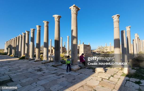 People visit the ancient Roman city of Leptis Magna, in the coastal Libyan city of Al-Khums, some 120Km east of the capital Tripoli, on February 4,...