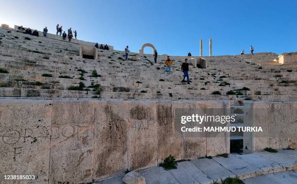 People visit the amphitheatre of the ancient Roman city of Leptis Magna, in the coastal Libyan city of Al-Khums, some 120Km east of the capital...