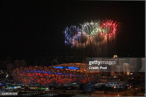 Fireworks in the shape of the Olympic rings go off over the National Stadium, known as the Bird's Nest, in Beijing, during the opening ceremony of...