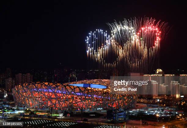 Fireworks in the shape of the Olympic rings go off over the National Stadium, known as the Bird's Nest, in Beijing, during the opening ceremony of...