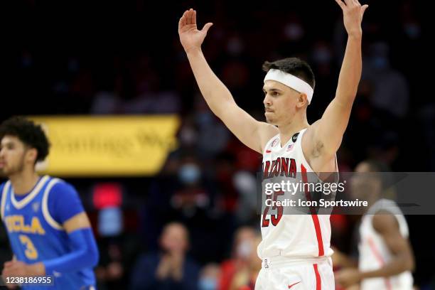 University of Arizona Wildcats guard Kerr Kriisa encourages the crowd to make some noise after a big play, in the second half of a basketball game...