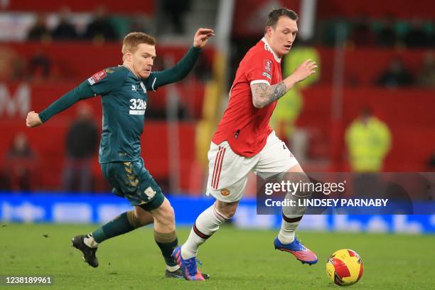 Manchester United's English defender Phil Jones vies with Middlesbrough's English striker Duncan Watmore during the English FA Cup fourth round...