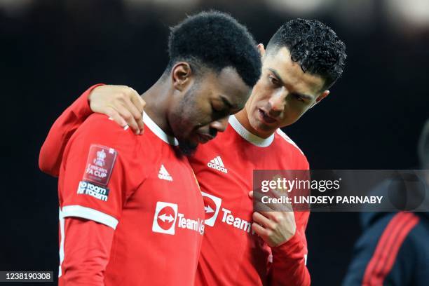 Manchester United's Portuguese striker Cristiano Ronaldo consoles Manchester United's Swedish striker Anthony Elanga after his penalty miss gave...