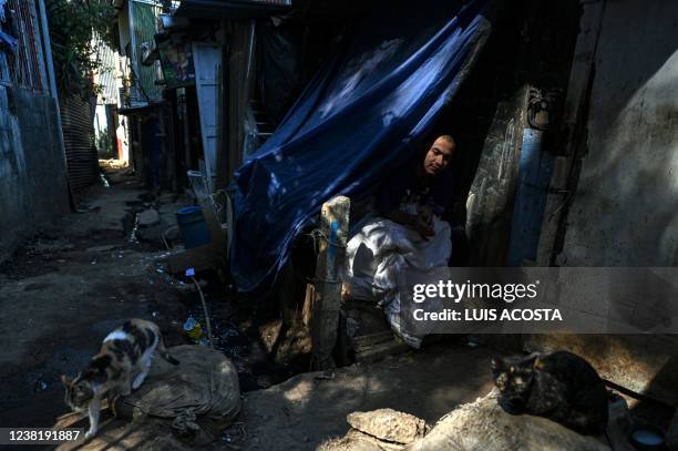 Man rests in a shack in El Erizo neighbourhood, in the province of Alajuela, Costa Rica, on January 4, 2022. - Costa Rica, one of the most stable...