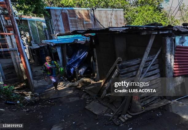 Man walks in a street of El Erizo neighbourhood, in the province of Alajuela, Costa Rica, on January 4, 2022. - Costa Rica, one of the most stable...