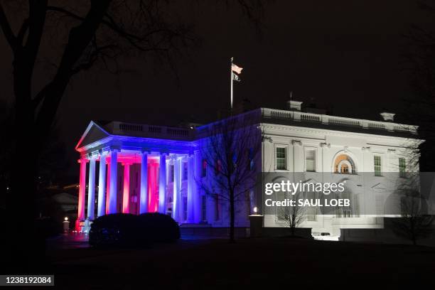 Red, white and blue lights in honor of US Olympians light up the north side of the White House in Washington, DC, February 4, 2022. - The Beijing...