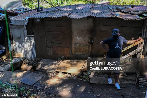 Man stands in a street of El Erizo neighbourhood, in the province of Alajuela, Costa Rica, on January 4, 2022. - Costa Rica, one of the most stable...