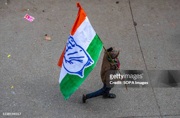 Congress party supporter holds a party flag during the roadshow of General Secretary of the AICC Priyanka Gandhi Vadra at Khora Colony, Ghaziabad.