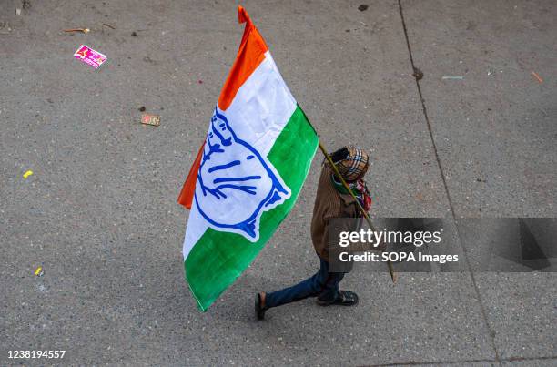 Congress party supporter holds a party flag during the roadshow of General Secretary of the AICC Priyanka Gandhi Vadra at Khora Colony, Ghaziabad.