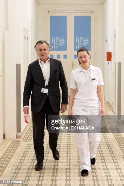 Lifebrain CEO Michael Havel and laboratory manager Anna Edermayr walk at the laboratory in Vienna on February 1, 2022. - Throughout the day, vans...