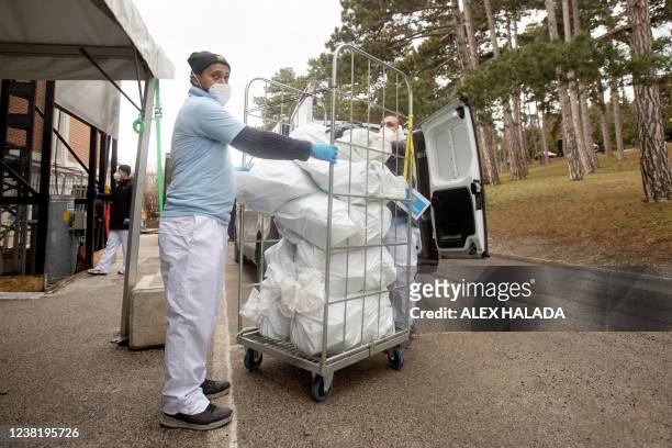 Employees of the LifeBrain company arrive with bags with coronavirus PCR gargle test samples, which are collected and delivered by a courrier...