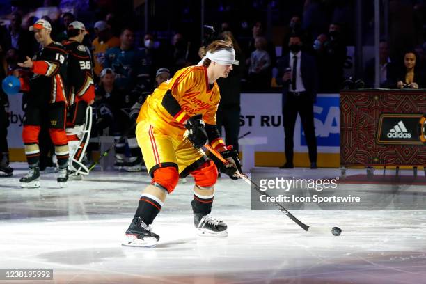 Trevor Zegras Anaheim Ducks forward handles the puck blindfolded while wearing an Average Joes uniform from the movie Dodgeball during the NHL...