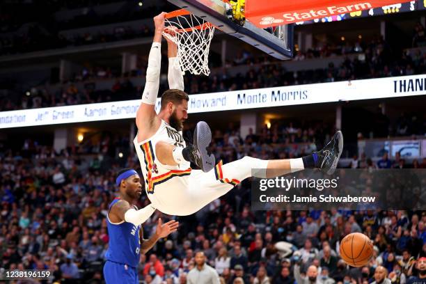 Jonas Valanciunas of the New Orleans Pelicans dunks against Will Barton of the Denver Nuggets at Ball Arena on February 4, 2022 in Denver, Colorado....