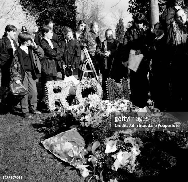 Mourners gathered around the grave and floral tributes at the funeral of notorious gangster Ronnie Kray at Chingford Mount Cemetary in London,...