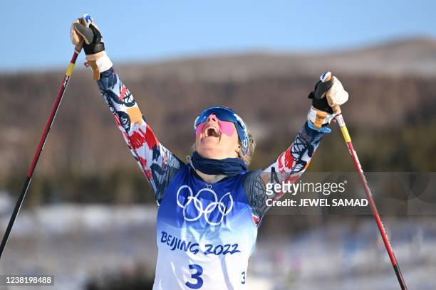 Norway's Therese Johaug celebrates after winning the women's skiathlon 2x7,5km event during the Beijing 2022 Winter Olympic Games on February 5 at...