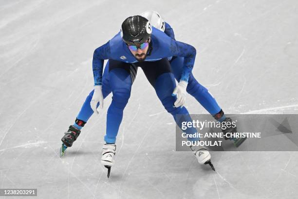 Kazakhstan's Denis Nikisha competes in the final B of the mixed team relay short track speed skating event during the Beijing 2022 Winter Olympic...