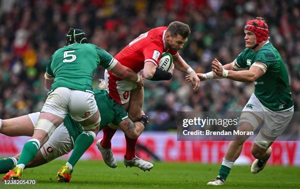 Dublin , Ireland - 5 February 2022; Dan Biggar of Wales is tackled by, from left, James Ryan, Andrew Porter and Josh van der Flier of Ireland during...