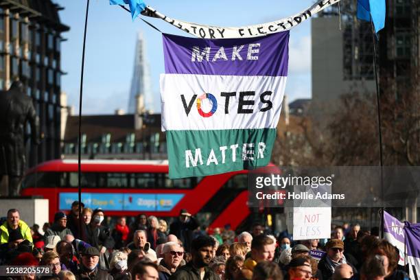 Demonstrators hold placards during the Say no to the Elections Bill rally in Parliament Square on February 5, 2022 in London, England. The protest is...