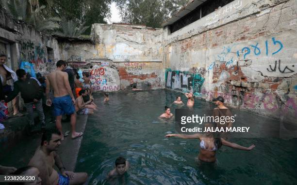Israelis bathe in a hot spring pool in a destroyed building which locals call Ein Jones, near Hamat Gader in the Israel-annexed Golan Heights near...