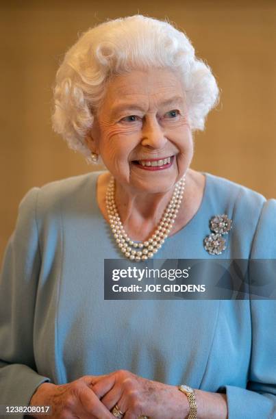 Britain's Queen Elizabeth II smiles during a reception in the Ballroom of Sandringham House, the Queen's Norfolk residence on February 5 as she...