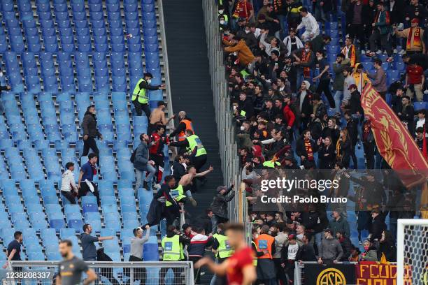 Roma and Genoa CFC fans fight during the Serie A match between AS Roma and Genoa CFC at Stadio Olimpico on February 5, 2022 in Rome, Italy.