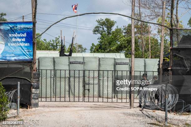 Armed guards stand outside a roadside security checkpoint and military compound in Narathiwat. Daily life around the Thai-Malaysian border on the...