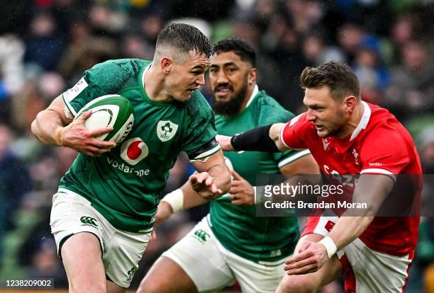 Dublin , Ireland - 5 February 2022; Jonathan Sexton of Ireland beats the tackle of Dan Biggar of Wales during the Guinness Six Nations Rugby...