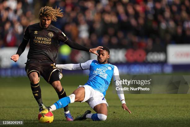 Bali Mumba of Peterborough United challenges Dion Sanderson of Queens Park Rangers during the Emirates FA Cup Fourth Round match between Peterborough...