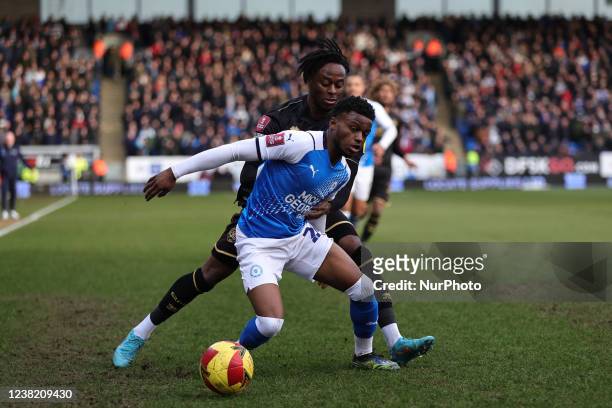 Bali Mumba of Peterborough United holds off Moses Odubajo of Queens Park Rangers during the Emirates FA Cup Fourth Round match between Peterborough...