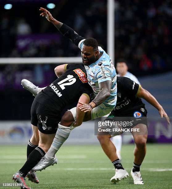 Racing's French outside centre Virimi Vakatawa is tackled by Brive's Irish inside centre Stuart Olding during the French Top 14 rugby union match...