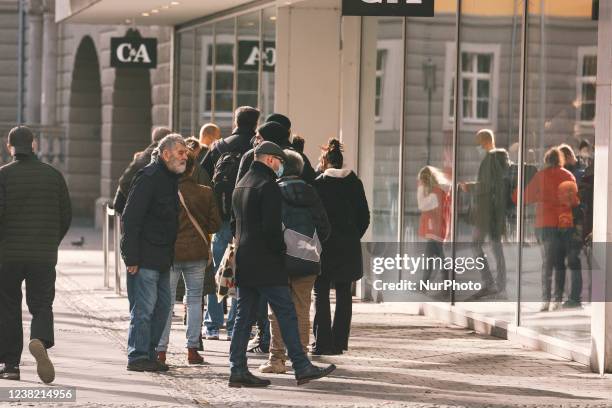 Shoppers are seen waiting in front of C &amp; A before allowing to enter the store in the city center of Bonn, Germany on Feb 5, 2022 as inflation in...