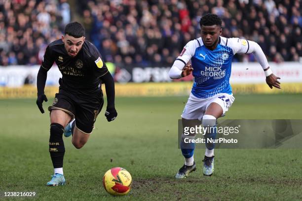 Ilias Chair of Queens Park Rangers and Bali Mumba of Peterborough United compete for possession during the Emirates FA Cup Fourth Round match between...