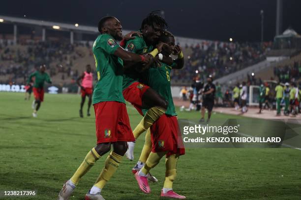 Cameroon's forward Karl Toko Ekambi, Cameroon's defender Olivier Mbaizo and Cameroon's defender Ambroise Oyongo celebrate their victory after the...