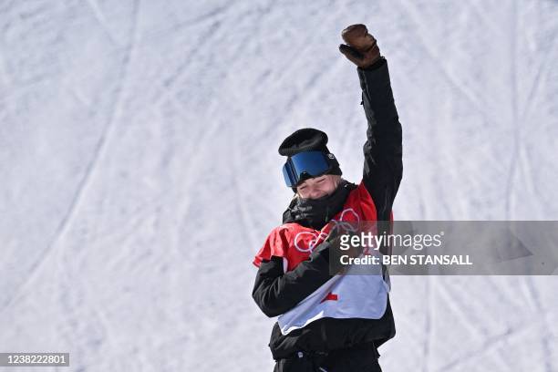 Gold medallist New Zealand's Zoi Sadowski Synnott gestures during the medals ceremony after the snowboard women's slopestyle final run during the...