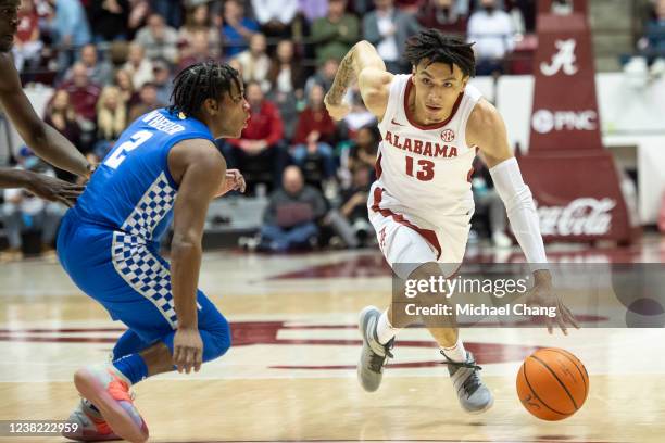 Jahvon Quinerly of the Alabama Crimson Tide looks to maneuver the ball by Sahvir Wheeler of the Kentucky Wildcats during the second half of play at...