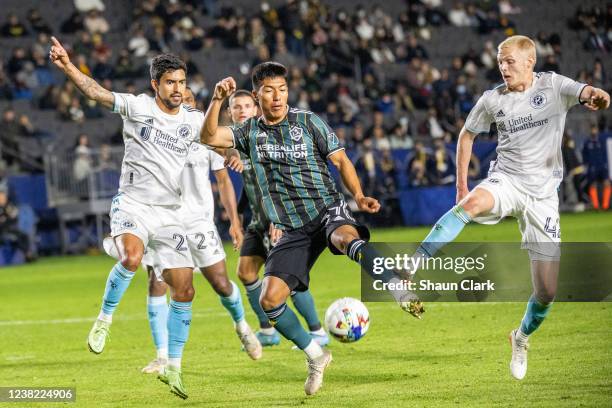 Daniel Aguirre of Los Angeles Galaxy is defended by A. J. DeLaGarza of New England Revolution during the match at the Dignity Health Sports Park on...