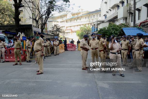 Police stand outside the Breach Candy hospital where Bollywood playback singer Lata Mangeshkar was admitted, in Mumbai on February 6, 2022. -...