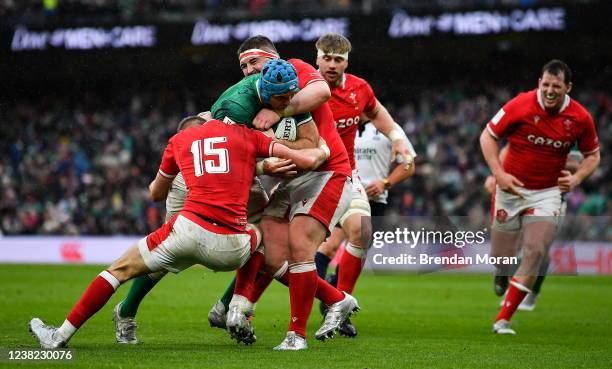 Dublin , Ireland - 5 February 2022; Tadhg Beirne of Ireland is tackled by Liam Williams and Wyn Jones of Wales during the Guinness Six Nations Rugby...