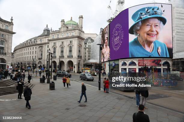 Portrait of Queen Elizabeth II is displayed on the large screen at Piccadilly Circus to mark the start of the Platinum Jubilee on February 6, 2022 in...