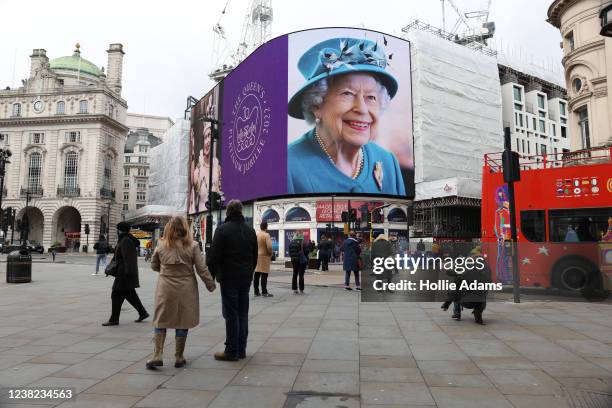 Portrait of Queen Elizabeth II is displayed on the large screen at Piccadilly Circus to mark the start of the Platinum Jubilee on February 6, 2022 in...