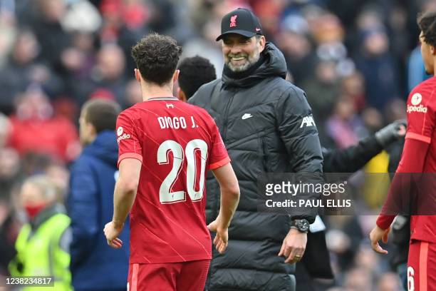 Liverpool's German manager Jurgen Klopp congratulates Liverpool's Portuguese striker Diogo Jota on the pitch after the English FA Cup fourth round...