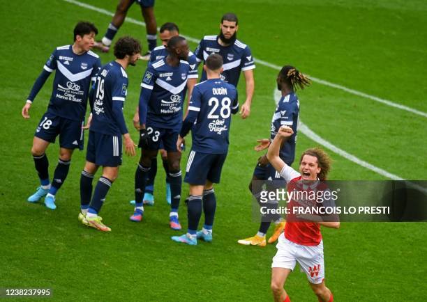 Reims' Belgian defender Wout Faes celebrates scoring his team's fifth goal during the French L1 football match Reims and Bordeaux at the Auguste...
