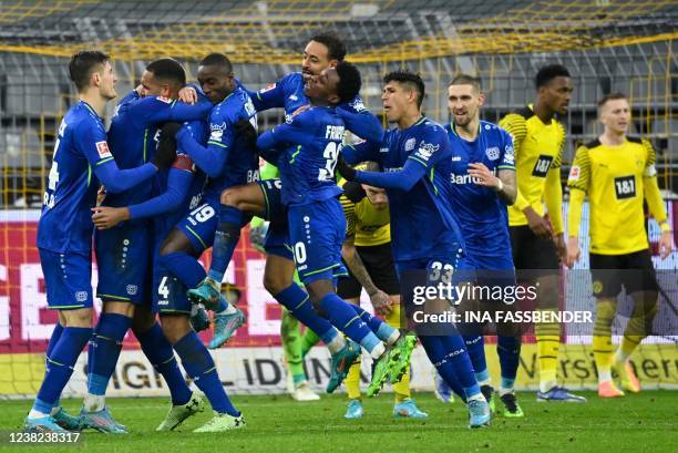 Leverkusen's German defender Jonathan Tah celebrates with teammates scoring his team's fourth goal during the German first division Bundesliga...