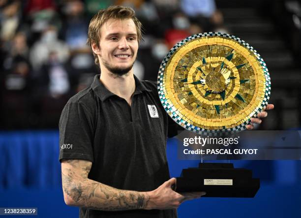 Kazakhstan's Alexander Bublik poses with his trophy after winning the final over German's Alexander Zverev of the ATP World Tour Open Sud de France...