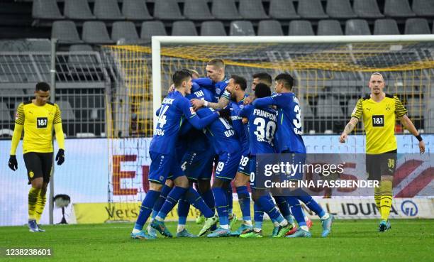 Leverkusen's German defender Jonathan Tah celebrates with teammates scoring his team's fourth goal during the German first division Bundesliga...