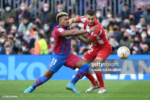 Barcelona's Spanish forward Adama Traore vies with Atletico Madrid's Spanish defender Mario Hermoso during the Spanish league football match between...